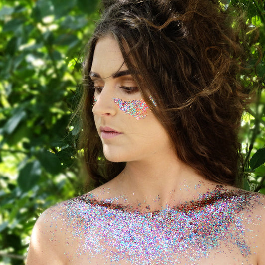 Female model with biodegradable glitter on her cheeks and collarbone
